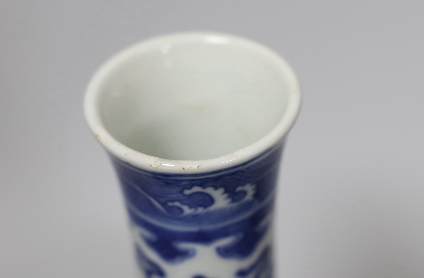 A late 19th century Chinese blue and white ‘eight Buddhist emblems’ vase, apocryphal Kangxi mark, 23cm